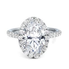 an oval cut diamond ring with pave set shoulders