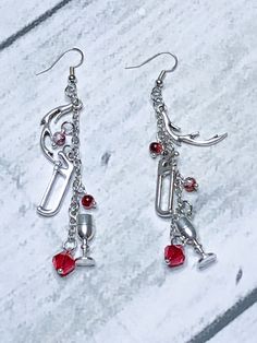 I finally got around to watching Hannibal and it's so gross and addicting. I really like am loving the style. So I made these elegant earrings that dangle with antlers, saws, and wine glasses, they are made to look beautiful and also a bit creepy. I added some bright red beads to finish it off.  due to the handmade nature of the product there could be some variations in beads but they will be as close to the photo as possible. Red Beads, Diy Wire Jewelry, Saws, Red Bead, Earrings Etsy, Elegant Earrings, Antlers, Bright Red, Wire Jewelry