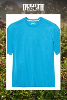 a blue t - shirt with the words duruth trading on it in front of some bushes