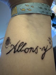 a woman's tattoo with the word alonys on her left side ribcage