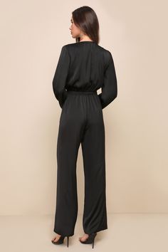 Take your daily looks to iconic new levels with the Lulus Trendsetting Direction Black Satin Tie-Front Wide-Leg Jumpsuit! Sleek woven satin shapes long balloon sleeves (with elastic at the cuffs) that frame a functional tie-front bodice with a V-neckline and a flirty cutout detail at the front. Banded waist has stretchy elastic at the back, and tops wide legs that end at ankle-grazing hems. Hidden zipper/clasp at side of pants. Fit: This garment fits true to size. Length: Floor length. Size medi Elegant Satin Long Sleeve Jumpsuits And Rompers, Elegant Long Sleeve Satin Jumpsuits And Rompers, Elegant Long Sleeve Satin Jumpsuit, Chic Long Sleeve Jumpsuits And Rompers With Elastic Waistband, Black Satin Jumpsuit, Jumpsuit Satin, Satin Jumpsuit, Pants Fit, Long Balloons