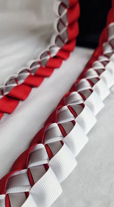 a red and white ribbon is on the bed