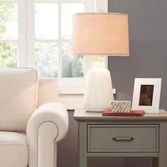 a living room scene with focus on the end table and lamp next to the chair