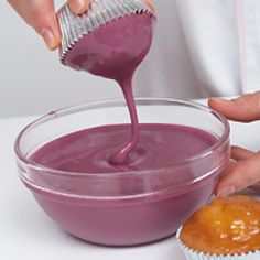 a person pouring purple liquid into a bowl