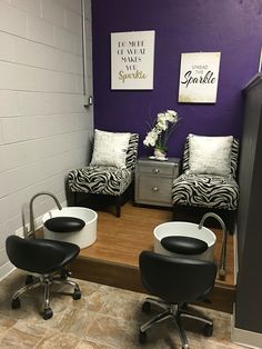 two zebra print chairs in front of a purple wall with black and white decor on it