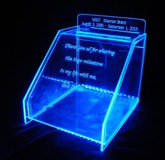 an illuminated display case in the dark with blue lights on it's sides and bottom