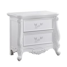 a white nightstand with two drawers on each side and an ornate design at the top