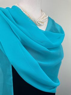 Elevate your style with our exquisite collection of chiffon shawls. Our chiffon shawls are the epitome of elegance and versatility, designed to effortlessly enhance your wardrobe and leave a lasting impression. Made from the fine poly chiffon fabric, these shawls offer a delicate and airy drape that adds a touch of grace to any outfit. Whether you're attending a special occasion, a casual gathering, or simply want to elevate your everyday look, our chiffon shawls are the perfect accessory. Choos Elegant Blue Scarves For Wedding, Elegant Blue Scarf For Wedding, Elegant Blue Silk Shawl Scarf, Elegant Blue Silk Shawl, Elegant Blue Shawl Scarves, Elegant Blue Shawl For Parties, Elegant Blue Silk Scarf For Wedding, Elegant Blue Scarves For Party, Elegant Blue Silk Scarf For Evening