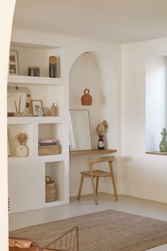 a room with white walls and shelves filled with items