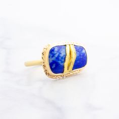 Inspired by the Japanese concept of Kintsugi, this lovely Lapis is thoughtfully mended together as one with two strips of delicately placed 22K gold ribbon. It sits atop an 18K gold open back setting and beautifully celebrates flaws and imperfections. Size 7 - please purchase a resize if you need a different size Japanese Concept, Lapis Ring, Gold Ribbon, Gold Ribbons, 22k Gold, Joinery, 18k Gold, Im Not Perfect, Ribbon