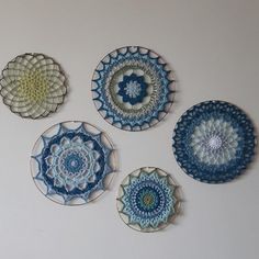 four decorative plates are arranged on the wall