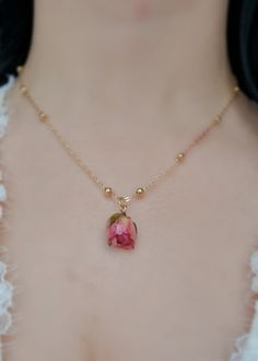 This Pink Rose necklace is a beautiful and unique piece of jewellery that features a real pink rose covered in resin. As a symbol of femininity, grace, and fresh love, this necklace is the perfect gift for a loved one on special occasions like Birthdays and Valentine's Day. The dried flower pendant is around 2 cm in size and hangs from a stylish 18k gold-plated chain that measures approximately 21 cm in length. Please note that as each piece is unique, the size may vary slightly due to natural v Dainty Rose Colored Necklace For Her, Feminine Rose Gold Jewelry With Rose Design, Dainty Rose Necklace As Gift For Her, Delicate Rose Gold Jewelry With Roses, Delicate Rose Gold Jewelry With Rose Design, Delicate Rose Design Rose Gold Jewelry, Rose Gold Jewelry With Roses For Her, Delicate Rose Gold Necklaces With Roses, Delicate Rose Gold Flower Necklace With Clavicle Chain