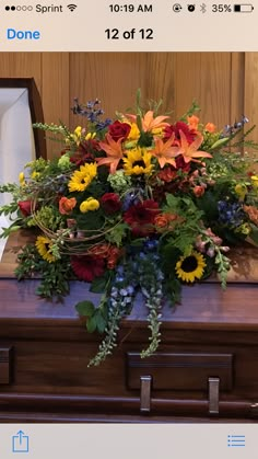 a bouquet of flowers sitting on top of a wooden box