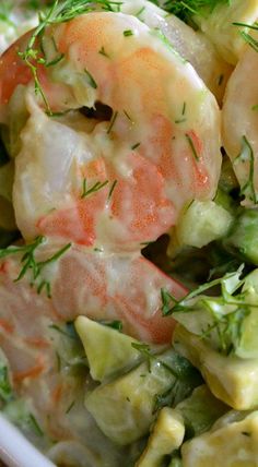 a bowl filled with shrimp and vegetables on top of a table