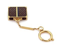 "Brand: Louis Vuitton Hallmark: Louis Vuitton Made in Italy Material: yellow gold finish metal Measurement: suitcase: 1.76\" tall x 1.77\" long x 0.43\" high Keyring Chain: 4\" long Weight: 105.4 grams This is an adorable Alzer Bag charm from Louis Vuitton, it has the famous brown color monogram logo small suitcase charm with yellow gold finish. The case opens to reveal a silver finish mirror inside. comes with a large round spring ring and a long bar tag hallmarked with the designer name. 23250 Luxury Yellow Gold Jewelry For Travel, Luxury Everyday Jewelry With Logo Charm, Luxury Rectangular Jewelry With Gold-tone Hardware, Luxury Brown Jewelry For Everyday Use, Beautiful Rings Vintage, Small Suitcase, Bag Jewelry, Designer Name, Vintage Branding