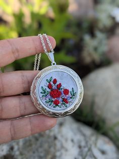 This pendant is hand embroidered.  This embroidered  locket necklace  is ready for shipment. Pendant size: 43mm  / 1,69" Size of central element:  30 mm / 1,18" Chain Length: 75 cm / 29,53"  (default, I can change the length of the chain) Clasp: none Pendant comes in a gift bag. Surface of embroidery is protected from moisture and dirt by professional impregnate. Every time I make embroidered jewerly, I fully engage myself. For every single embroidery i spent many hours and prepare several proje Traditional Embroidered Jewelry For Gifts, Traditional Silver Embroidered Jewelry, Vintage Jewelry With Floral Embroidery For Gift, Handmade Silver Locket Necklace With Round Pendant, Handmade Silver Locket Necklace For Keepsake, Memory Locket, Paint Background, Silver Lockets, Locket Necklace