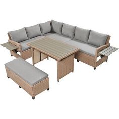 an outdoor patio furniture set with grey cushions and gray cushions on the back, including a table