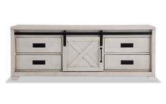 a white dresser with black handles and drawers