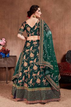 Bottle green bridal circular lehenga in Taffeta Silk bridal wedding designer lehenga with Thread, Dori, Zari, Sequins Embroidery Work all over.
Accompanied by a similarly embroidered Taffeta Silk choli in matching green colour and two green & orange net dupatta with laced borders. Designer Green Lehenga With Floral Embroidery, Green Lehenga With Floral Embroidery For Diwali, Green Floral Embroidered Lehenga For Diwali, Fitted Green Lehenga With Floral Embroidery, Bollywood Style Green Lehenga With Floral Embroidery, Green Bollywood Lehenga With Floral Embroidery, Green Lehenga With Floral Embroidery For Navratri, Festive Green Lehenga With Floral Embroidery, Bollywood Style Green Choli With Floral Embroidery