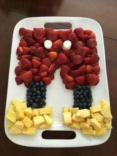 a tray with fruit cut into the shape of a man