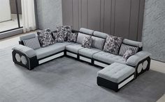 a large sectional couch sitting on top of a gray rug