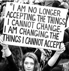 a woman holding up a sign that says i am no longer accepting the things i cannot change, i am changing the things i cannot accept