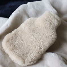 Made in Somerset, England, UK these cosy sheepskin hot water bottle covers are a must-have! This standard bottle cover slips on easily and is refiled through an opening on the top. These shearling covers are ideal to gently ease and warm, muscle pain, in your back, shoulder, and toes. You can be assured that even the hottest bottle will not burn and the dense sheepskin keeps the bottle warm all night long.  The hot water bottle is not included with the cover. Material - 100% Sheepskin  General c Fur Hot Water Bottle, Hot Water Bottle Aesthetic, Hot Water Bottles, Bottle Covers, Somerset England, Hot Water Bottle Cover, Water Bottle Covers, Bottle Warmer, Hot Water Bottle