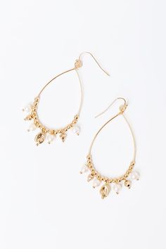 - Sip your mimosa with a sweet pop of pearls with these gorgeous earrings! - Gold colored metal material - A dangling teardrop shaped design with patterned beading featuring faux pearl accents - Hook backs - Size: 2.5 inches Teardrop Pearl Drop Chandelier Earrings For Party, Gold Teardrop Hoop Earrings With Pearl Charm, Party Pearl Teardrop Earrings, Metal Beaded Drop Earrings With Pearl, Metal Teardrop Earrings With Pearl Drop, Teardrop Chandelier Earrings With Pearl Drop, Gold Teardrop Beaded Hoop Earrings, Teardrop Pearl Drop Chandelier Earrings, Gold Beaded Teardrop Earrings In Metal