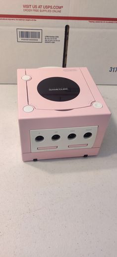 a pink electronic device sitting on top of a table