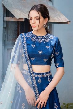 Blue lehenga with embroidered floral motifs. Comes with blouse and sheer dupatta.
Components: 3
Fabric: Raw silk, Net
Neckline: Round
Sleeve Length: Elbow
Color: Blue
Embroidery
Hand embroidery
Embroidered floral motifs on blouse
Embroidered floral motifs on dupatta
Side tassel tie-up detail on lehenga - Aza Fashions Varun Chakkilam, Sheer Dupatta, Blue Lehenga, Embroidered Lehenga, Embroidery Hand, Blue Embroidery, Floral Motifs, Embroidered Silk, Embroidered Blouse