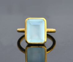 This beautiful bezel set ring is made with large rectangular faceted Aqua Chalcedony in 18K Vermeil Gold. The ring has a 925 stamp. Gemstone size is 13 x 18 mm. This ring is available in two finishes: ✦ 18K VERMEIL GOLD ✦ BRIGHT STERLING SILVER - - - - - - - - - - - - - - - Ring will be shipped in Danique Jewelry branded box. ★ Different shipping options including EXPEDITED SHIPPING are available at the checkout. - - - - - - - - - - - - - - - Please visit my full collection of RINGS: http://www. Rectangular Faceted Ring As A Gift, Elegant Gold Rectangular Crystal Ring, Gold Rectangular Crystal Ring, Classic Rectangular Crystal Ring As Gift, Classic Crystal Rectangular Ring, Classic Rectangular Crystal Ring Gift, Aqua Chalcedony Ring, Rectangle Ring, March Birthstone Ring