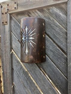 a rusted metal object on the side of a wooden door