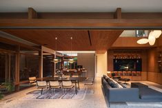 a living room filled with furniture and a wooden ceiling