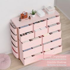 a pink dresser with many drawers on it