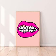 a pink poster with teeth on it in front of a white wall and wooden floor