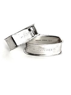 two silver rings with the words marriage written on them