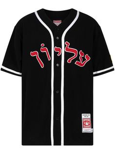 a black baseball jersey with red and white letters on the chest, in front of a white background