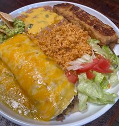 a white plate topped with tacos and rice