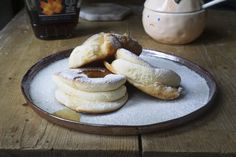 some powdered sugar covered pastries on a plate