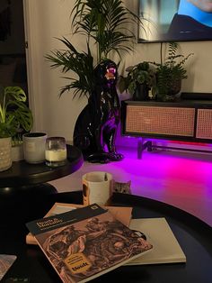 a table with some books and plants on it