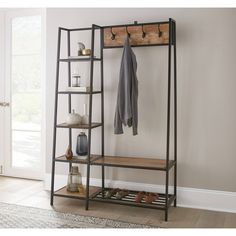 an entryway with a coat rack and shoes