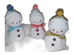 three stuffed snowmen with hats and scarves