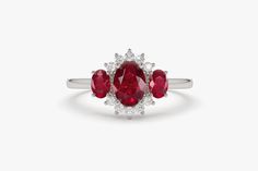 "Ruby Ring / 14k Three Stone Natural Ruby Cluster Ring / Classic Genuine Ruby Engagement Ring 14k Gold / July Birthstone / Promise Ring Features *Made to Order *Gold Kt: 14K (also available in 18K) *Available Gold Color: Rose Gold, Yellow Gold, White Gold *Oval Shape Ruby: 1 pc 6 x 4MM *Oval Shape Ruby: 2 pc 4x3MM *Round Diamonds: 10 pcs 1.55 MM *Ruby CTW: 1.23 ctw *Diamond CTW: 0.16 ctw *Ready to Ship in 7-10 Business Days If you have any additional questions about this product, just hit the \" Luxury Ruby Three Stone Rings, Formal White Gold Ruby Ring With Three Stones, Classic Red Three Stone Rings, Classic Red Three-stone Ring, Classic Ruby Cluster Ring With Gemstone, White Gold Cluster Ring With Gemstone, Anniversary White Gold Ruby Ring With Halo, Classic Cluster Gemstone Rings, Fine Jewelry Ruby Ring With Halo For Anniversary