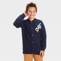 Get your child geared up for the chilly season with this Sonic the Hedgehog Letterman Bomber Jacket. Made of a midweight cotton blend, this long-sleeve jacket sports a full-length snap button front, side welt pockets and ribbed edges for functional flair and a neat look. Sonic's colorful image on the chest and his striking illustration on the back as well as "Sonic" embroidered in yellow and a white label in Japanese, complete the design and take this simple navy blue jacket to the next level. Fleece Outerwear For School In Fall, Winter School Cotton Outerwear, Casual Fleece Outerwear For School, Winter Cotton Outerwear For School, Winter School Fleece Outerwear, Cotton Outerwear With Ribbed Cuffs For School, Long Sleeve Cotton Outerwear For School, School Outerwear With Button Closure And Long Sleeves, Playful School Outerwear For Fall