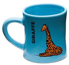 a blue coffee mug with a giraffe on it and a yellow cup next to it