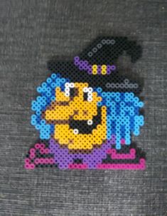 a piece of art made out of perler beads with an image of a cartoon character on it