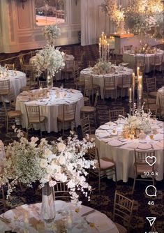 a room filled with lots of tables covered in white flowers