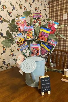 a bucket filled with seed packets sitting on top of a wooden table