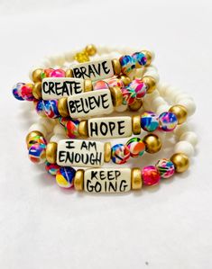 Affirmation bracelets featuring a hand-lettered affirmation focal bead and abstract print beads Stretchy to fit most wrists. Bead size - 8mm Focal bead - 18mm 7.75" centerline Beaded Bracelet Thick, Diy Stacking Bracelets, Letter Bracelets Ideas, Jewelry Making With Beads, Positive Affirmation Bracelets, Friendship Bracelets Designs With Beads, Letter Bracelet Ideas, How To Make Bead Bracelets, Homemade Bracelets With Beads