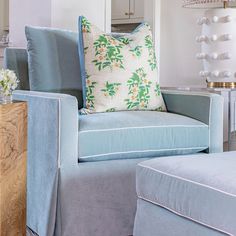 a blue chair and ottoman in a living room